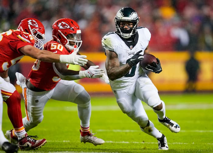 Philadelphia Eagles running back D'Andre Swift (0) runs the ball against Kansas City Chiefs linebacker Willie Gay (50) and defensive end George Karlaftis (56) during the first half at GEHA Field at Arrowhead.